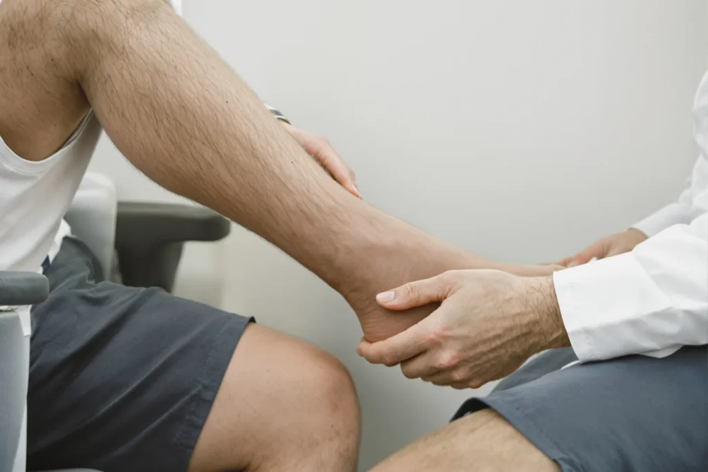 Runner discussing a foot injury with a physician